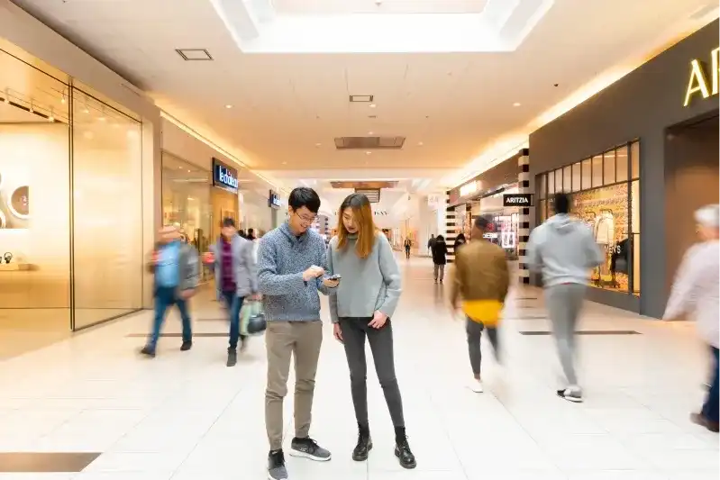 Shoppers standing in a mall image