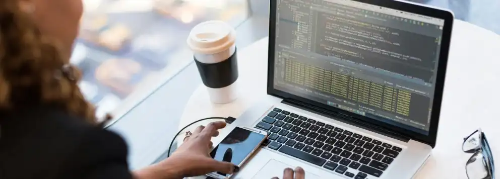 A women coding at a laptop