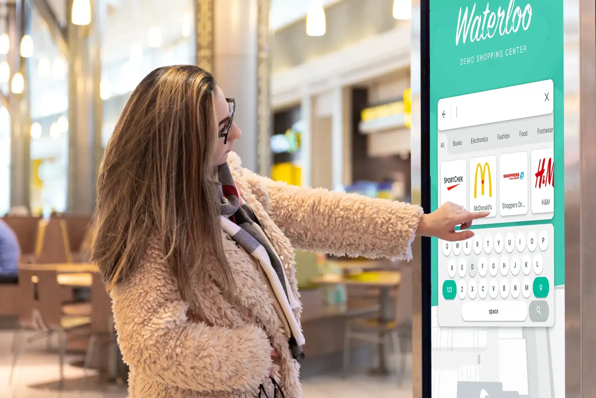 Person interacting with a digital map kiosk