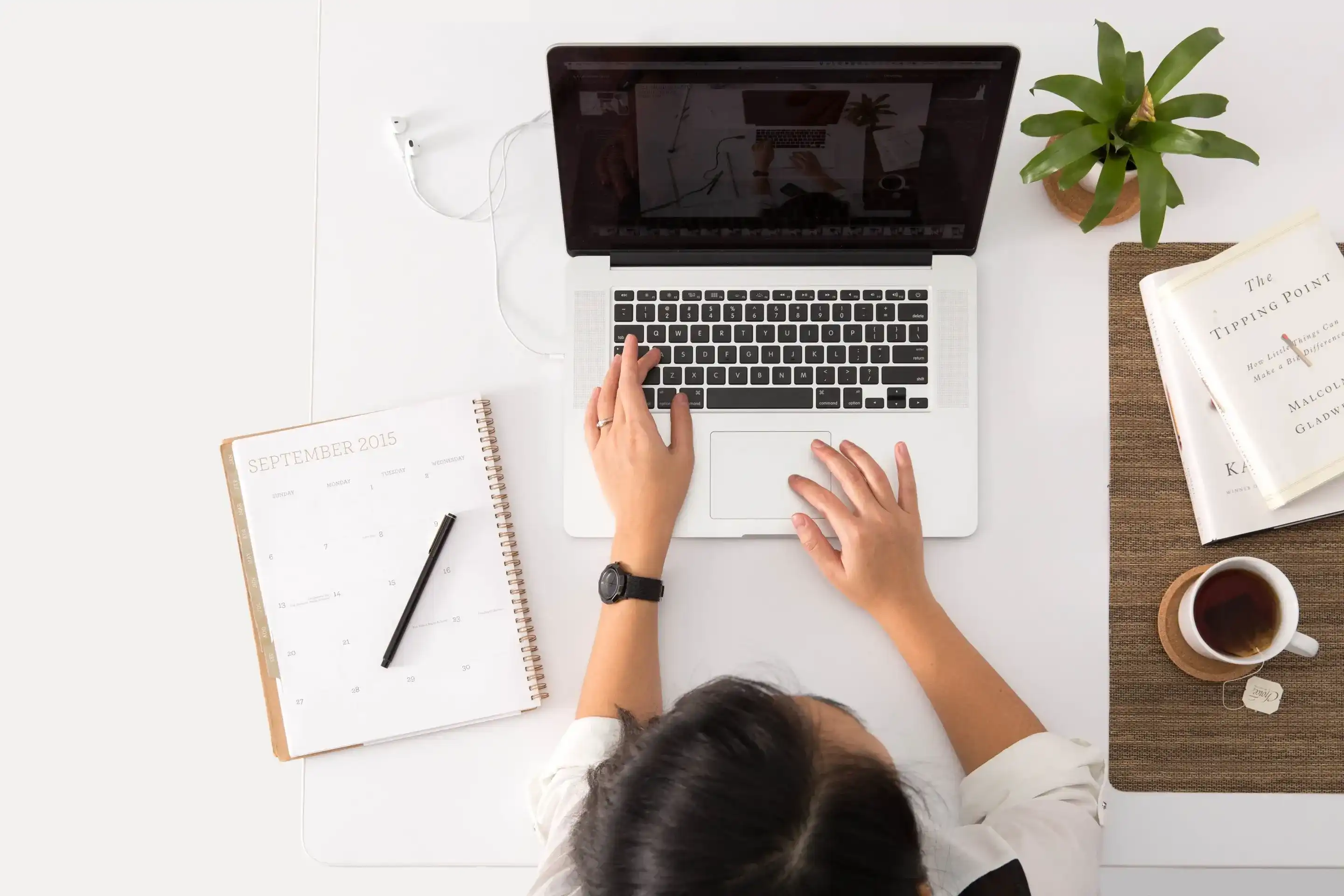 Overhead view of person sitting at desk with laptop